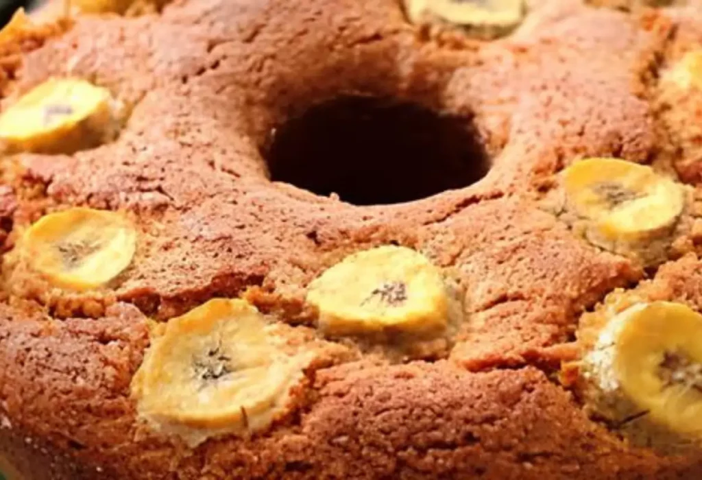 um bolo de banana com pedaços de banana em cima .