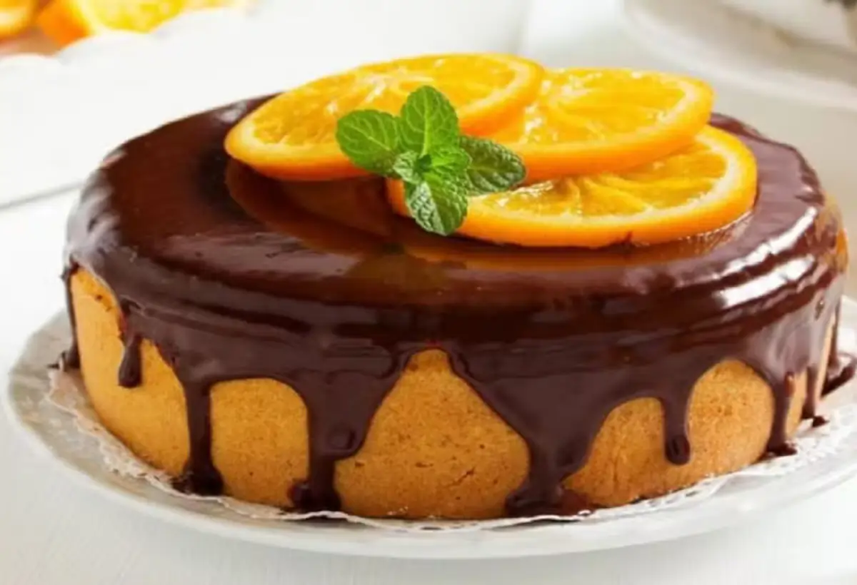 Uma travessa com Bolo de laranja low carb com calda de chocolate.