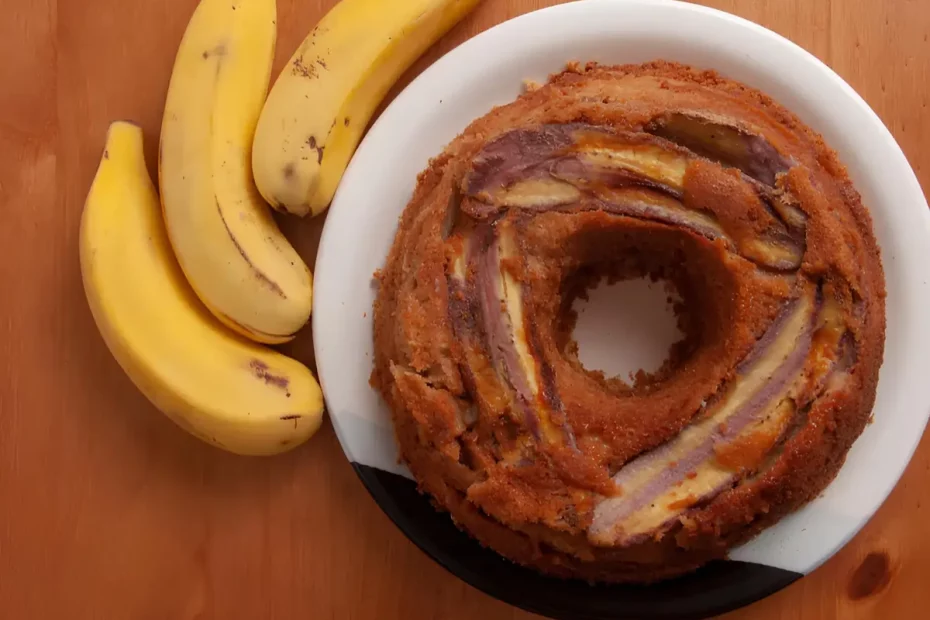 Um prato com um bolo de banana de três bananas ao lado para decorar a mesa.