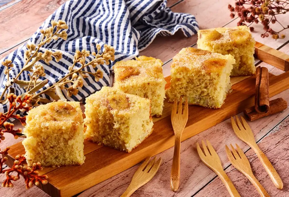 Uma mesa decorada com café da manhã com uma mesinha de fatias de Bolo de Banana com Flocos de Milho.