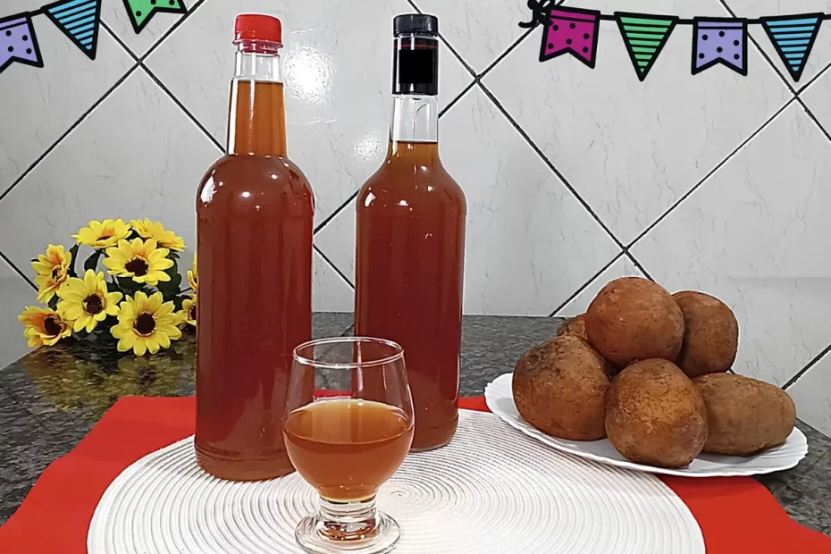 Uma mesa decorada para festa junina com duas garrafas de vidro com um copo de licor de jenipapo com gengibre.