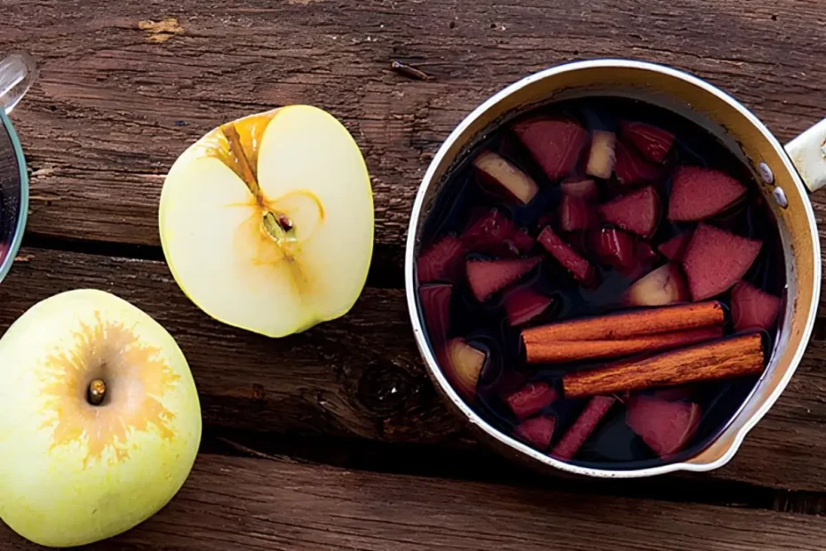 uma panela com vinho quente com maçã